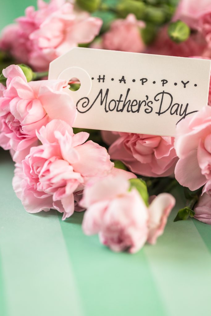 Pink flowers for Mother's Day on stripe paper.